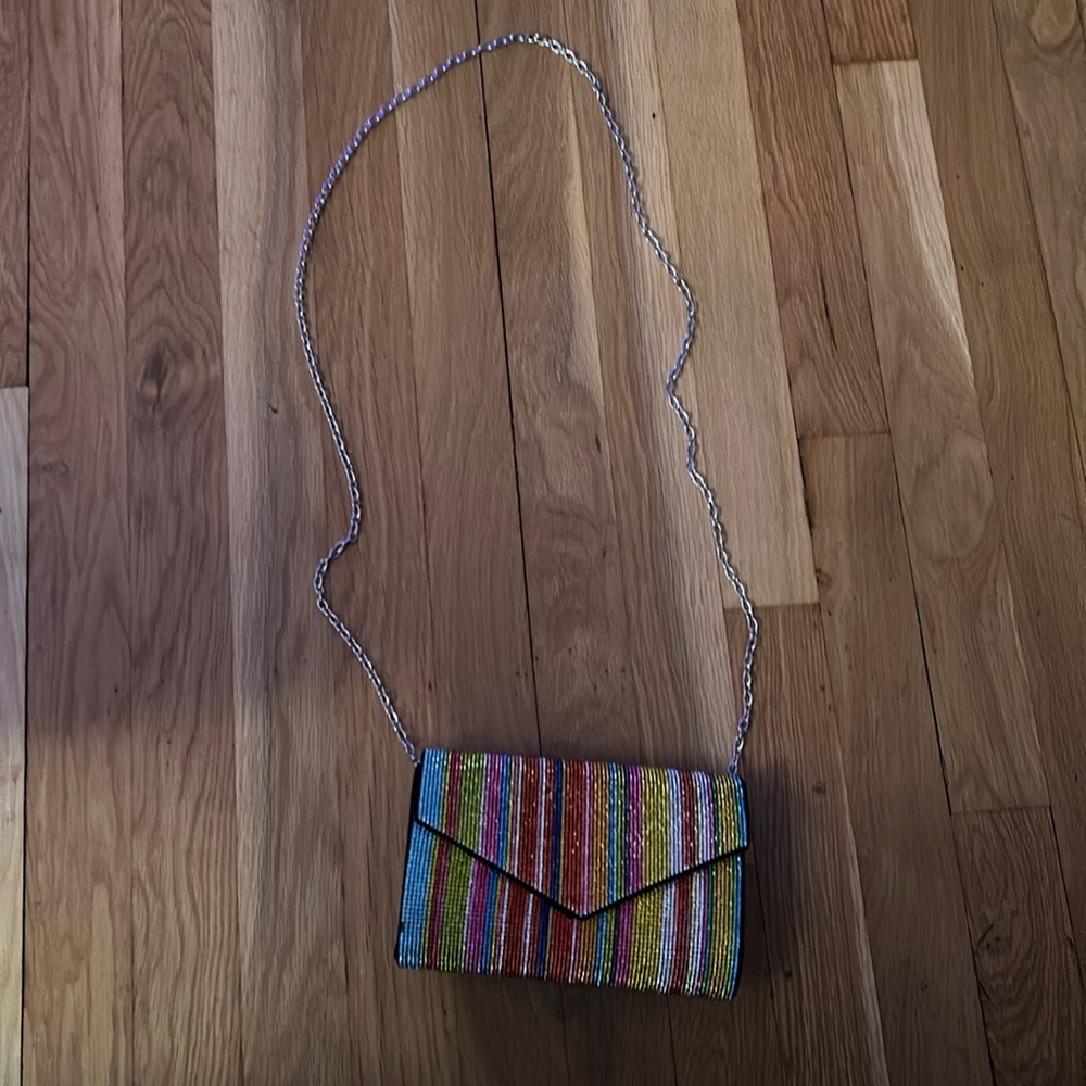 Used multi colored bag with detachable straps